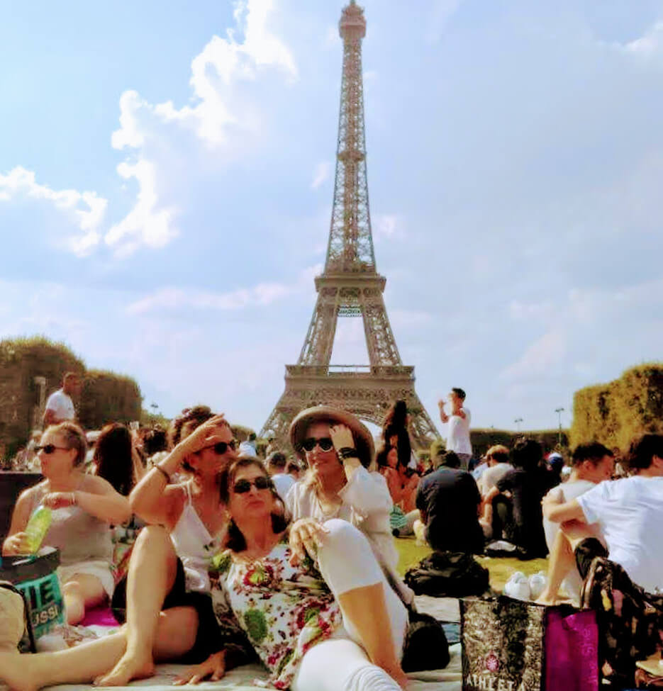 Adrian Leeds and friends lounging on the lawn at the Eiffel Tower in Paris