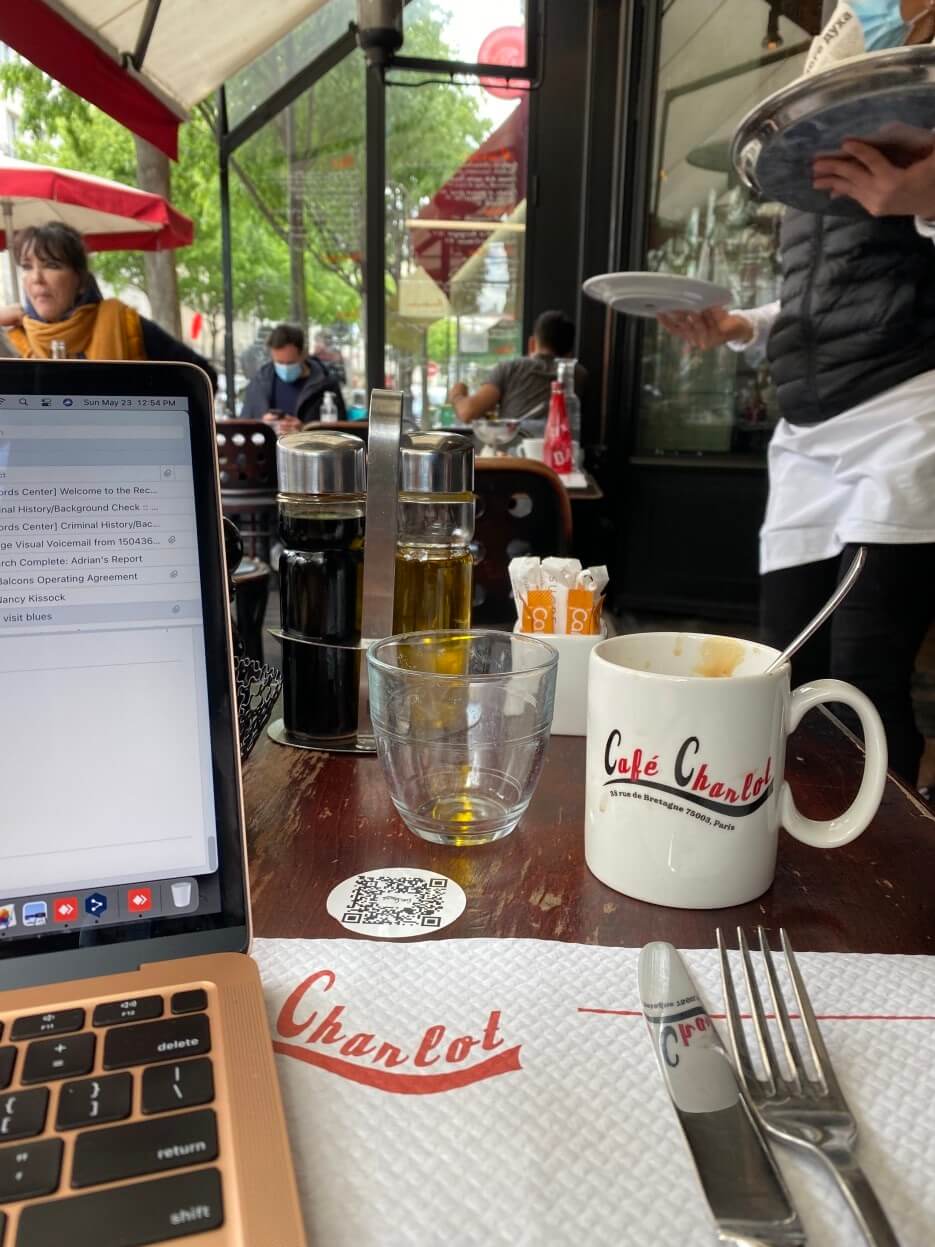 Adrian Leeds on her laptop at Café Charlot in Paris
