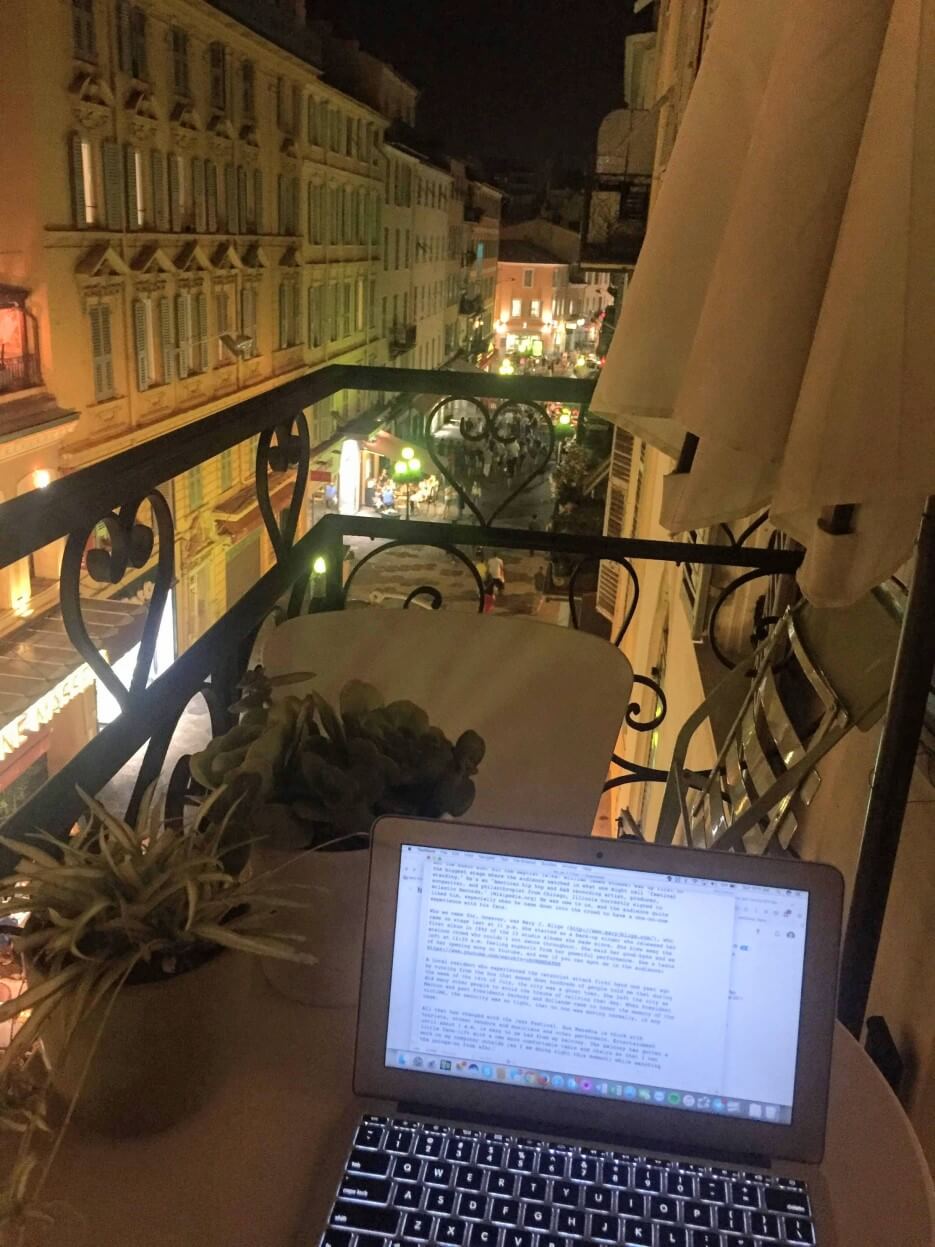 Adrian Leeds on her laptop at a café on the balcony of her apartmet in Nice