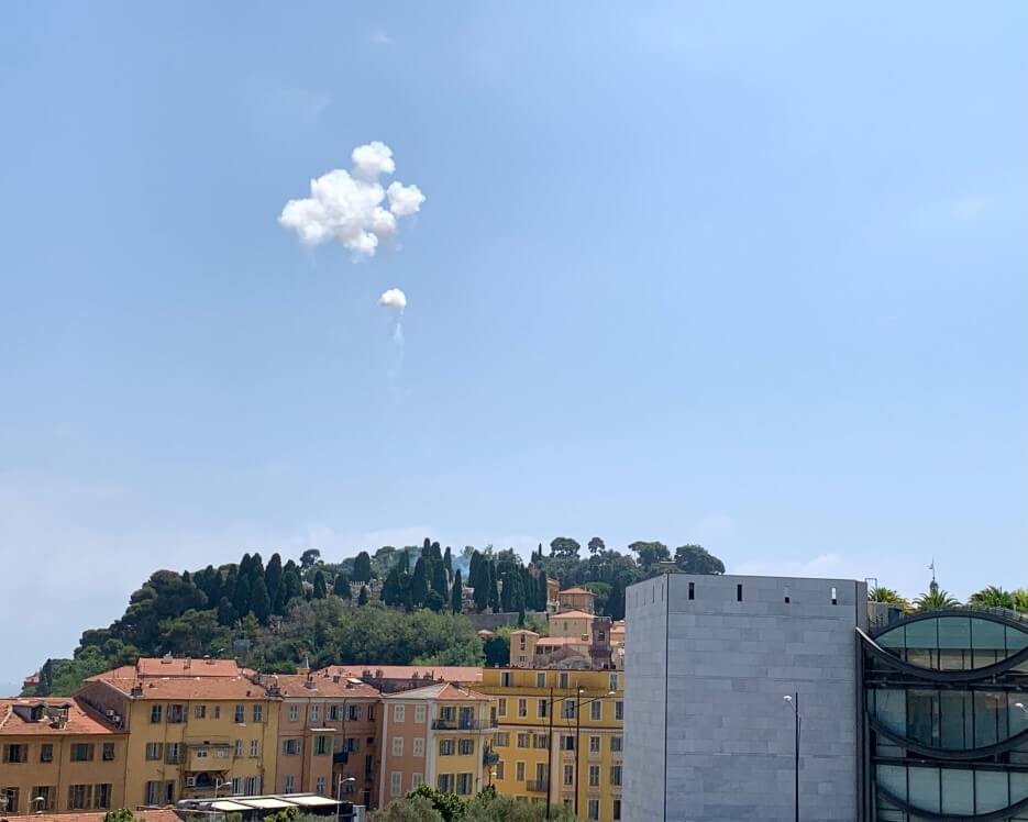 Puffs of smoke from the noonday canon in the sky in Nice