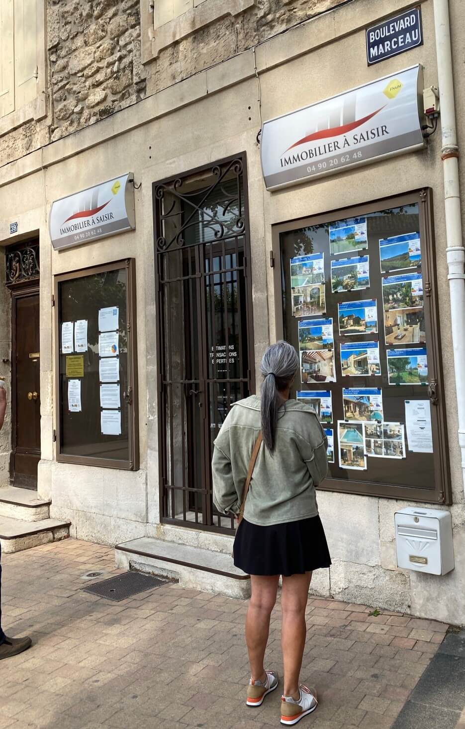 View of the listings in the window of a real estate office in Paris