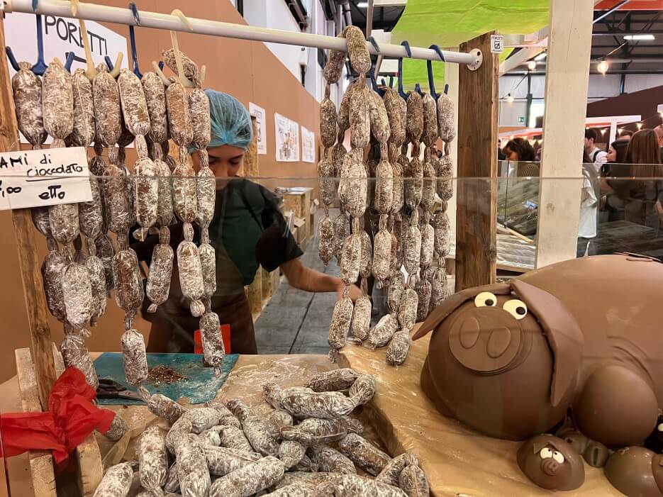 A sausages stand with chocolate pig sculpture at Eurochocolate