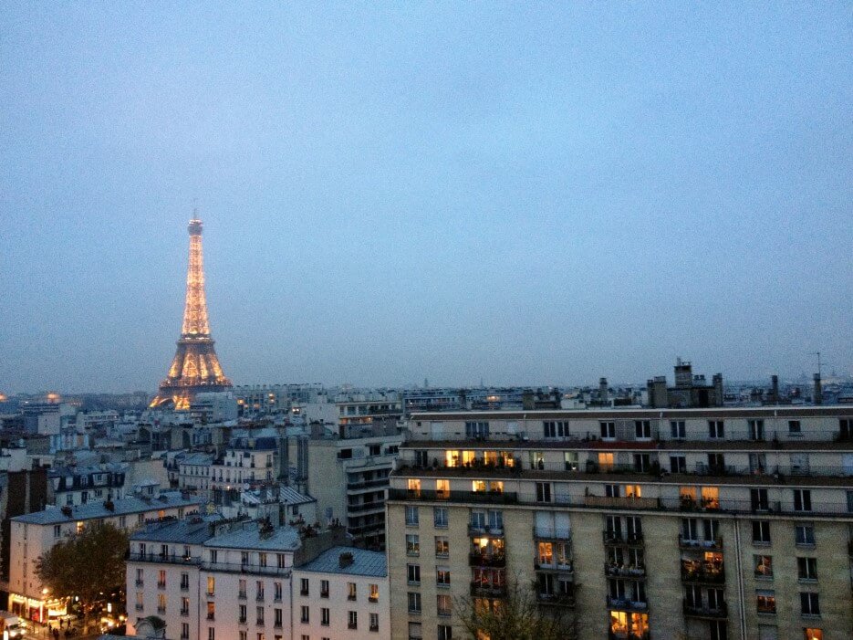 View of Paris buildings on a cloudy evening with the Eiffel Tower in the back ground
