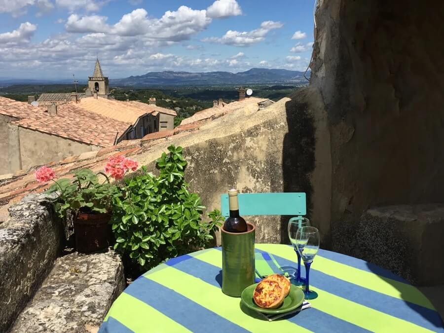 On the terrace of the apartment for sale, looking out over Venasque, France in the Vaucluse