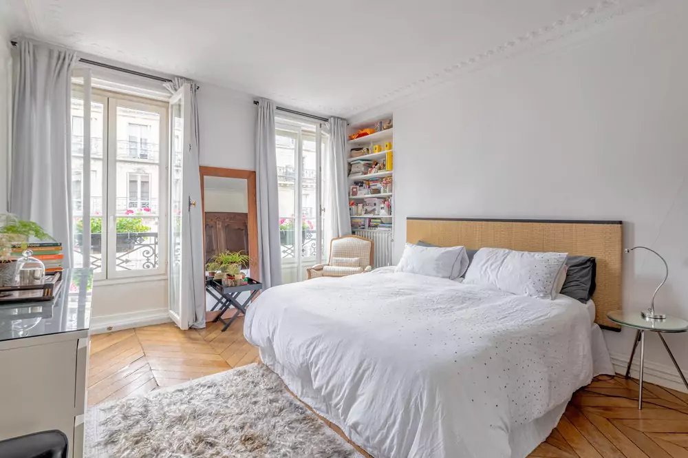 large bedroom with storage and large windows 11 rue Madame Paris