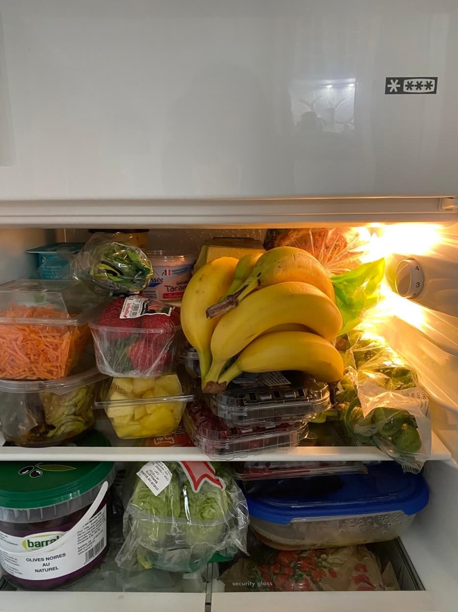 A small French refrigerator filled with food