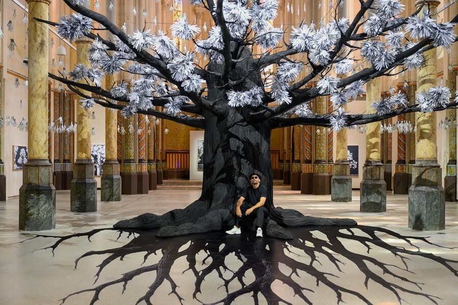 Artist JR and his tree in the nave for his exhibit Adventice in Carré Sainte-Anne, Montpellier