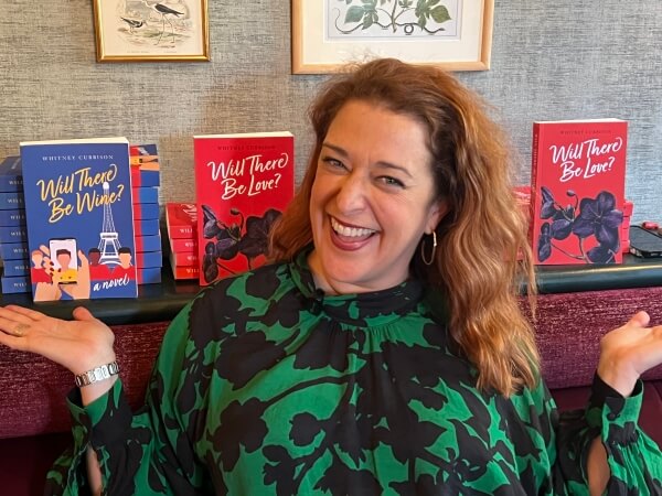 Whitney Cubbison at Apres-Midi Paris with her books on display