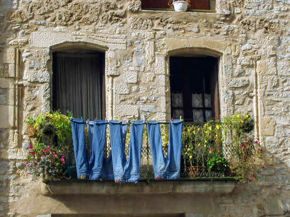 Jeans hanging on balcony in Occitanie