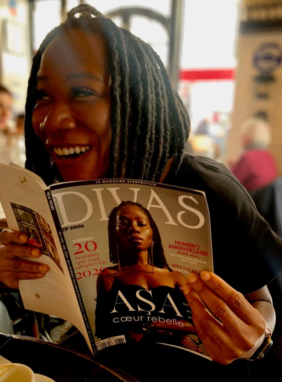 Asa holding a copy of DIVAS with her photo on the cover