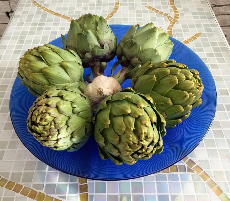 A bowl of uncooked artichokes