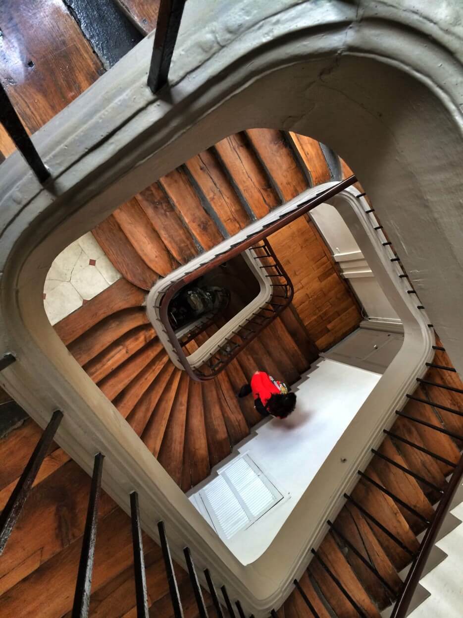 Looking down the spiraling staircase in the building of Adrian Leeds' apartment in Paris