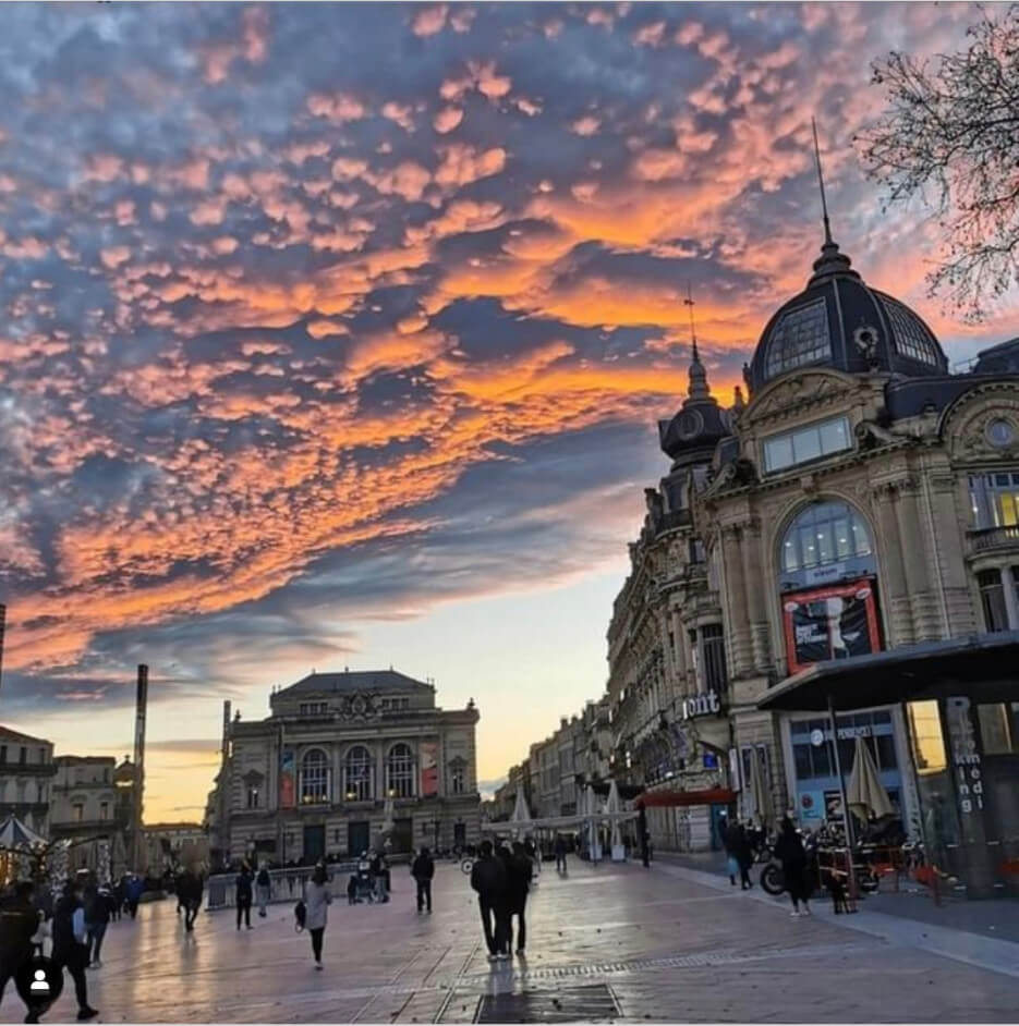 A sunset, cloudy sky over Place de la Comedie in Montpellier, France