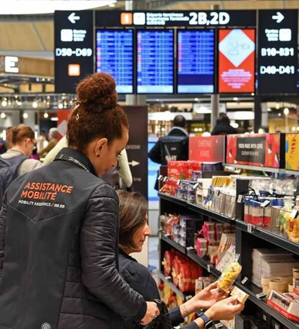 Adrian Leeds Wheelchair shopping at Charles de Gaulle airport in Paris