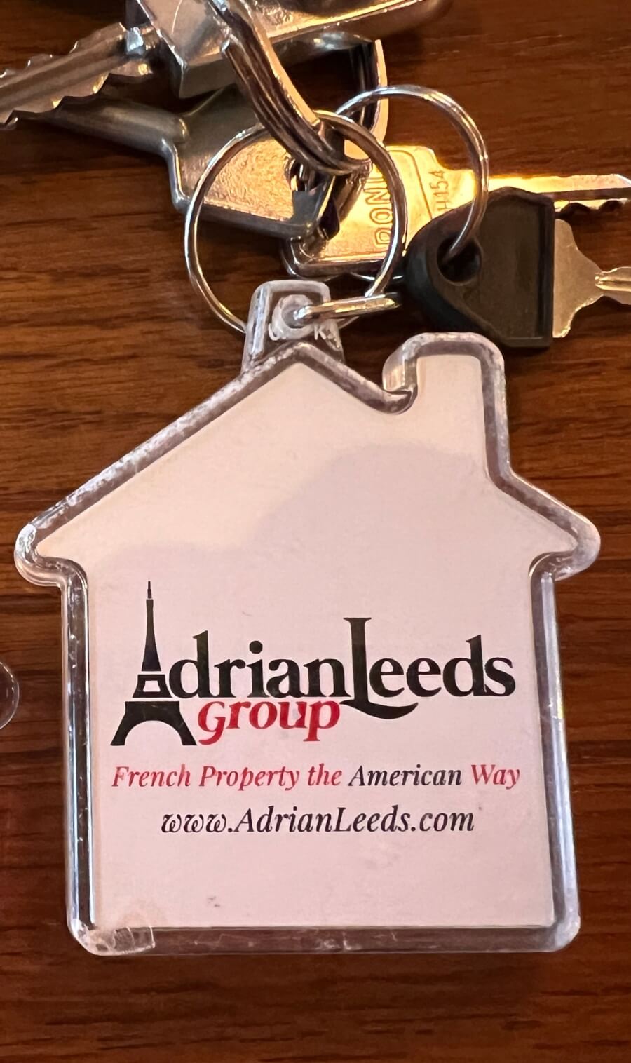 An Adrian Leeds Group key chain with keys to a French apartment