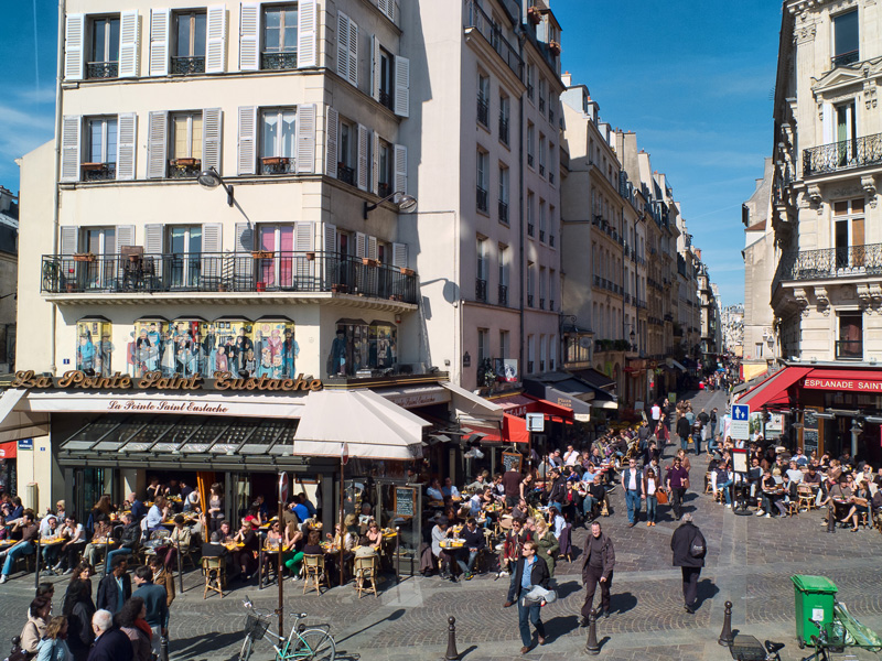 Busy street with cafes and shops on Rue Montorgueil