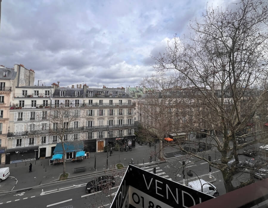 Apartment buildings in Paris, France with a for sale signs
