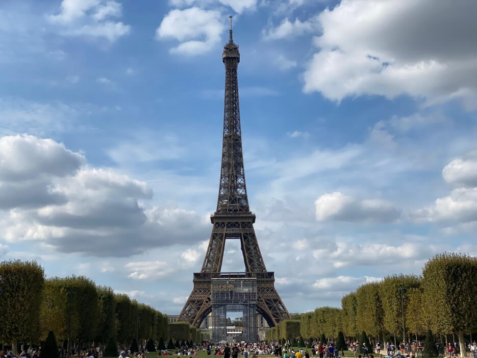 The Eiffel Tower in Paris against blue skies and clouds