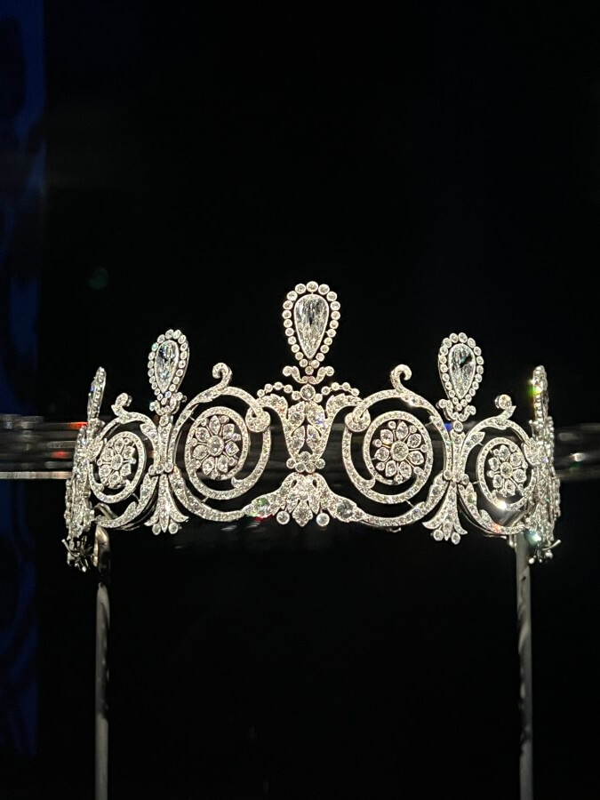 A diamond tiara at the Al Thani collection oh exhibit at Promotional poster for the Joyaux Dynastique exhibit at The Hôtel de la Marine in Paris, France