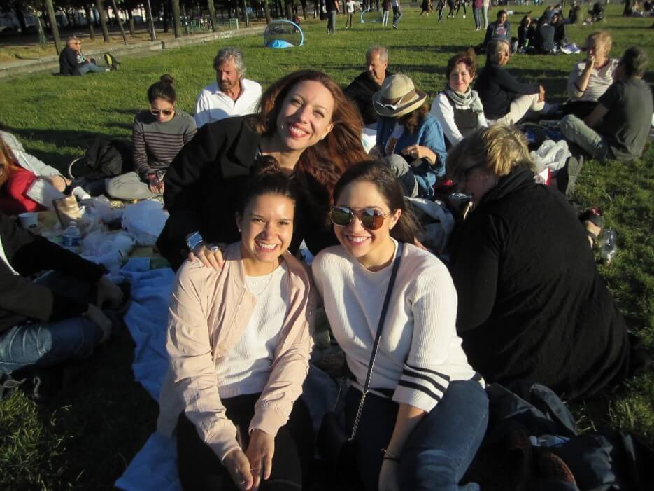 Friends picnicking on a lawn in Paris