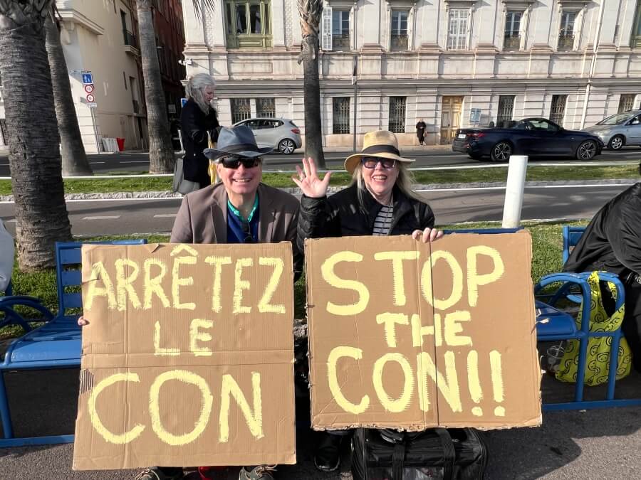 Adrian Leeds' friends with their Stop the Con signs at the No Kings rally in Nice, France