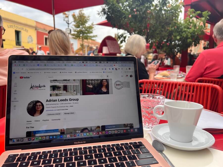 Adrian Leeds' laptop open on a cafe table in Paris