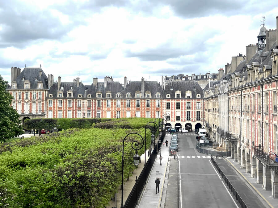 View of Place des Vosges in front of Maison Victor Hugo in Paris