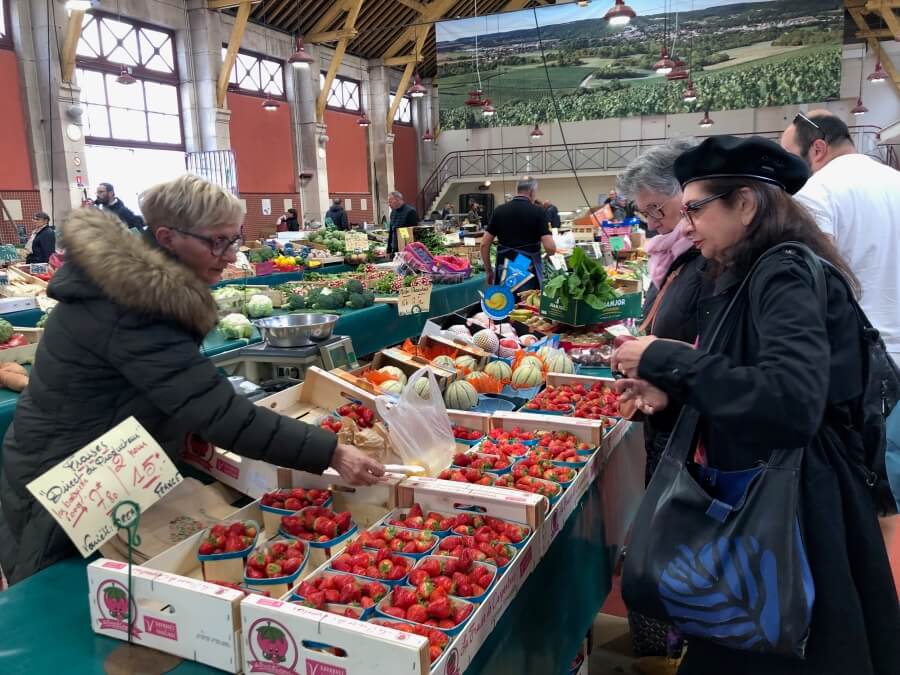 Adrian Leeds buying strawberries at the market in Bar sur Aube, France