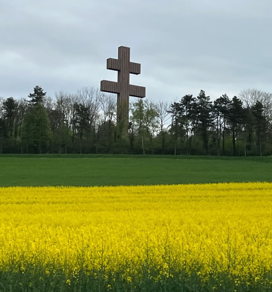 Countryside field of Colza and the Cross of Lorraine