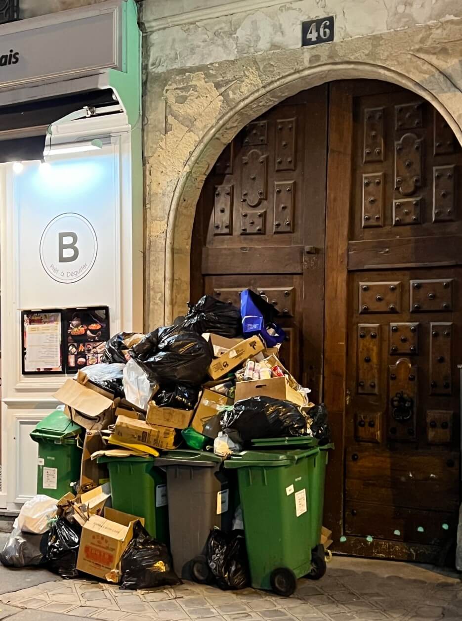 Garbage piled up in front of an apartment building in Paris
