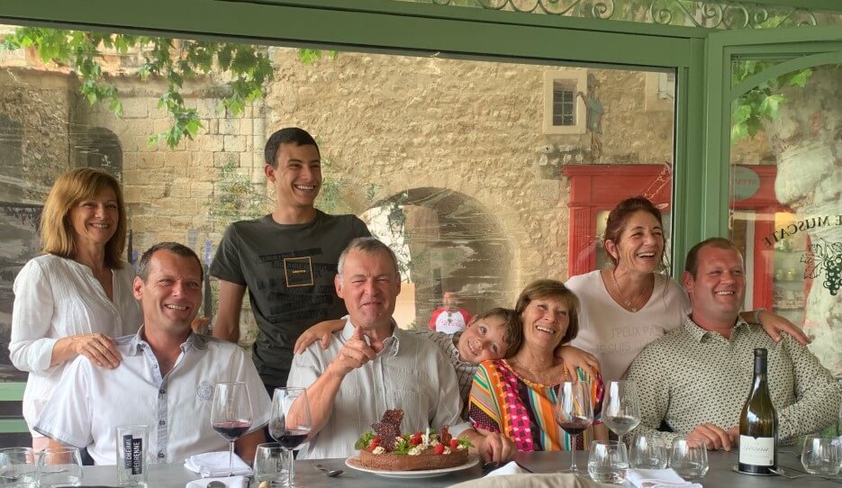 A French family's group photo at the dinner table
