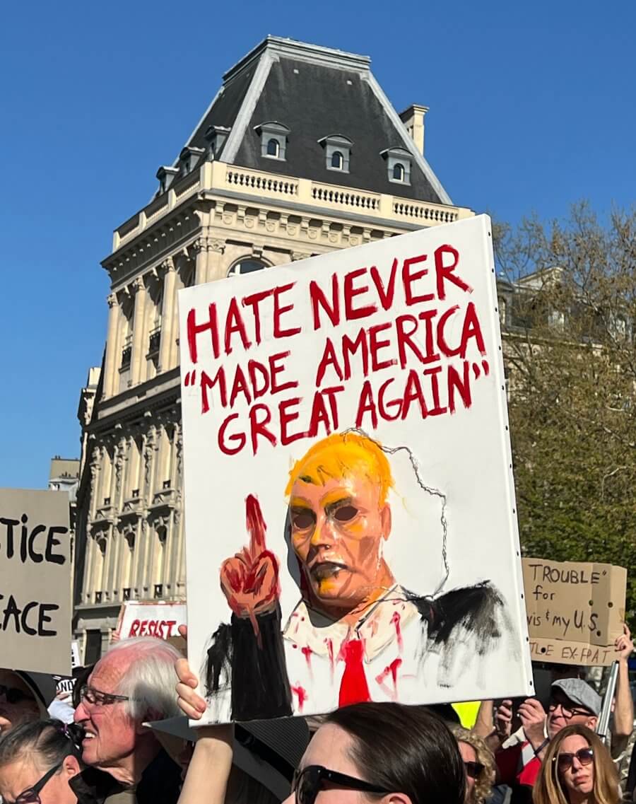 A handmade poster at the Hands Off protest in Paris, France