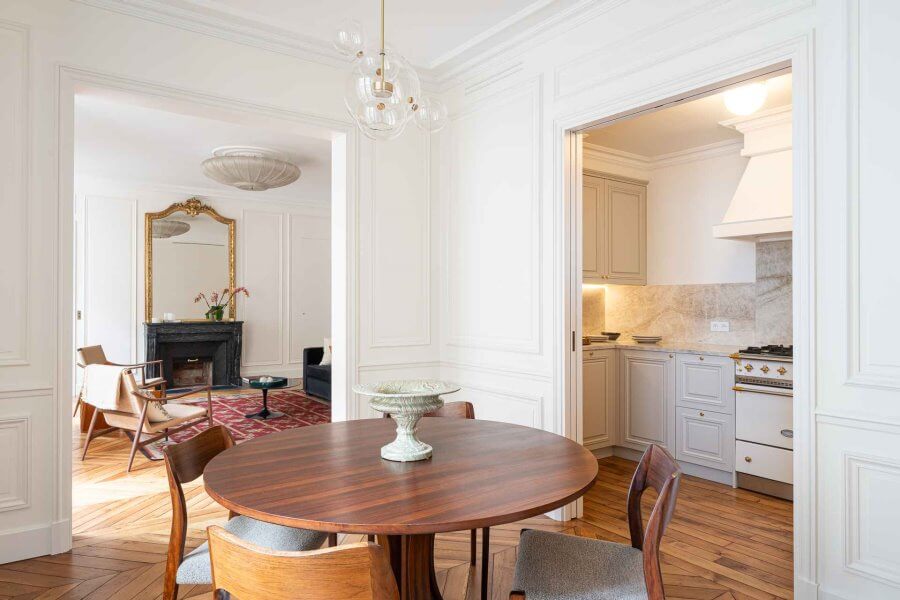 View of dining room, living room, and kitchen of the Fractional property rue des Beaux Arts in Paris