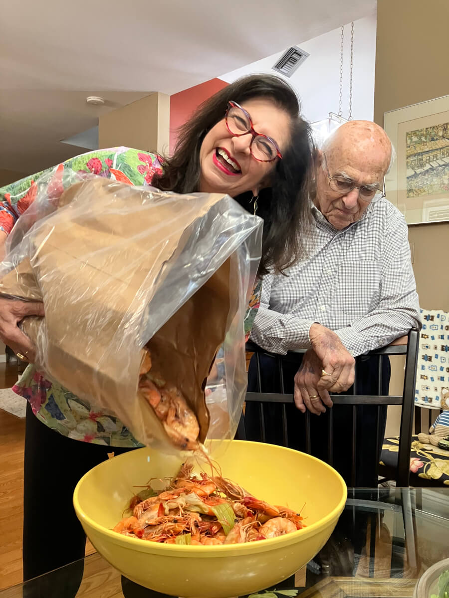 Pouring almost 10 pounds of boiled shrimp into the bowl, with Adrian Leeds' brother-in-law, Joe
