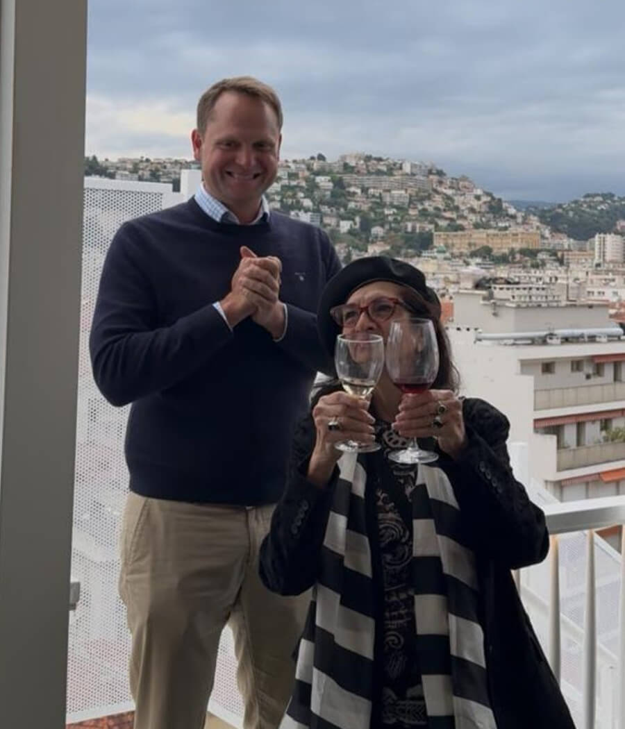Adrian Leeds with Brian Dunhill clinking wine glasses to get the group's attention