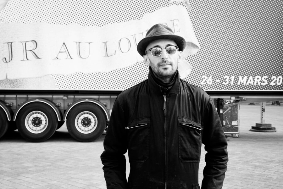 Photo by Erica Simone of JR at the Louvre Project http://www.ericasimone.com