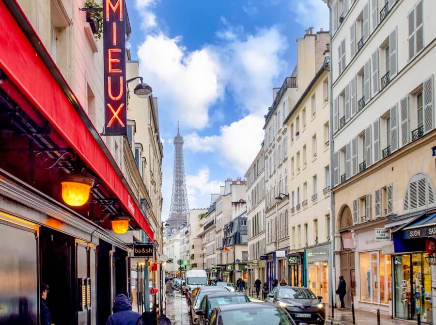 View of the Eifel Tower down a Paris street
