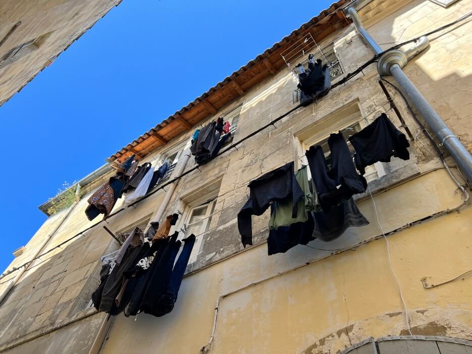 Laundry hanging on the balconies of an apartment in Arles