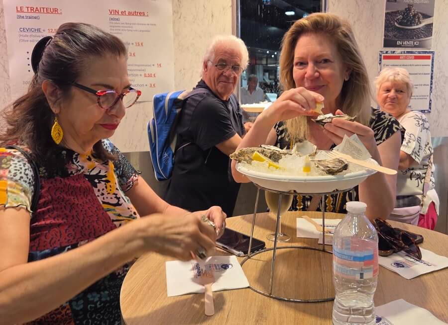Adrian Leeds and Jennifer Parrette enjoying oysters at the Marché Victor Hugo