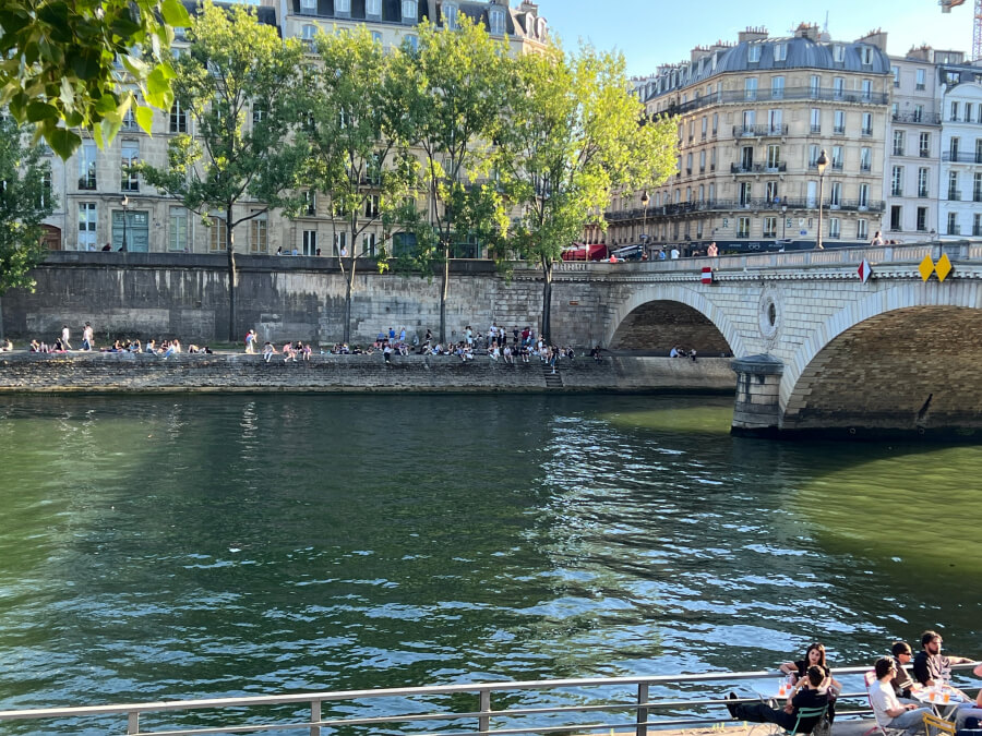 Parisians sunning along the banks of the river Seine in Paris, France
