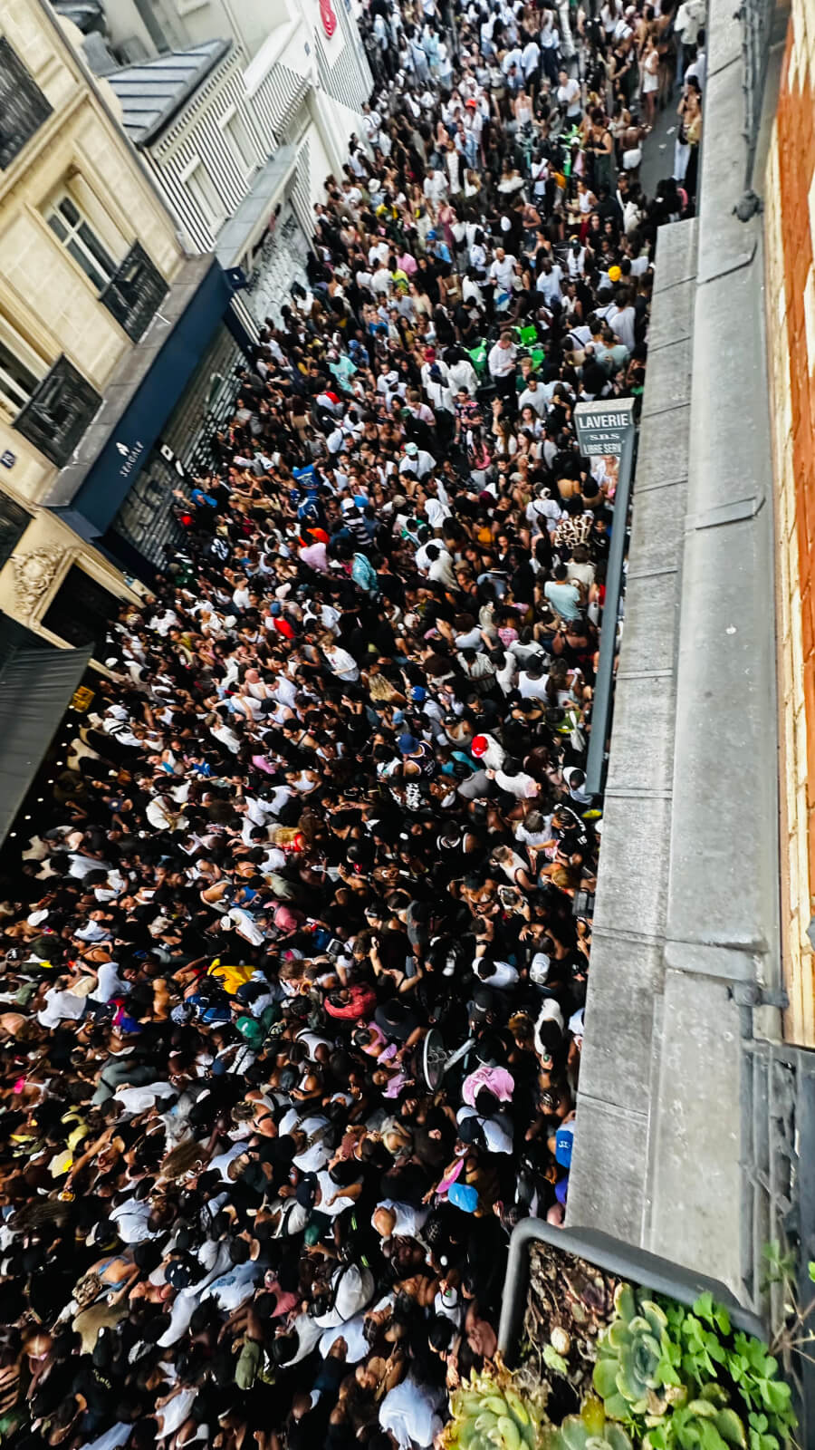 The Fête de la Musique crowd packed around the entrance to Adrian Leeds' apartment building in Nice, France
