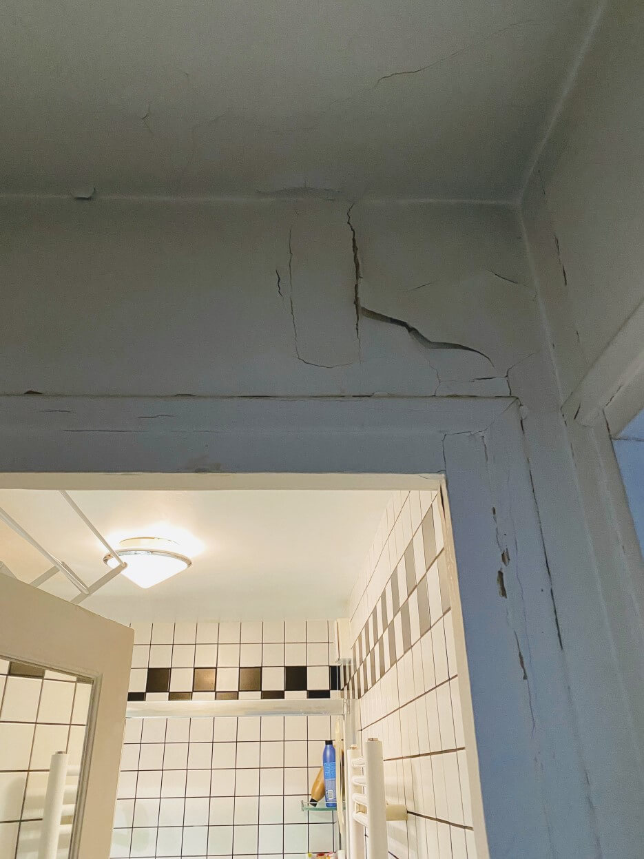 Photo of the cracked doorframe in Adrian Leeds' apartment in Paris France