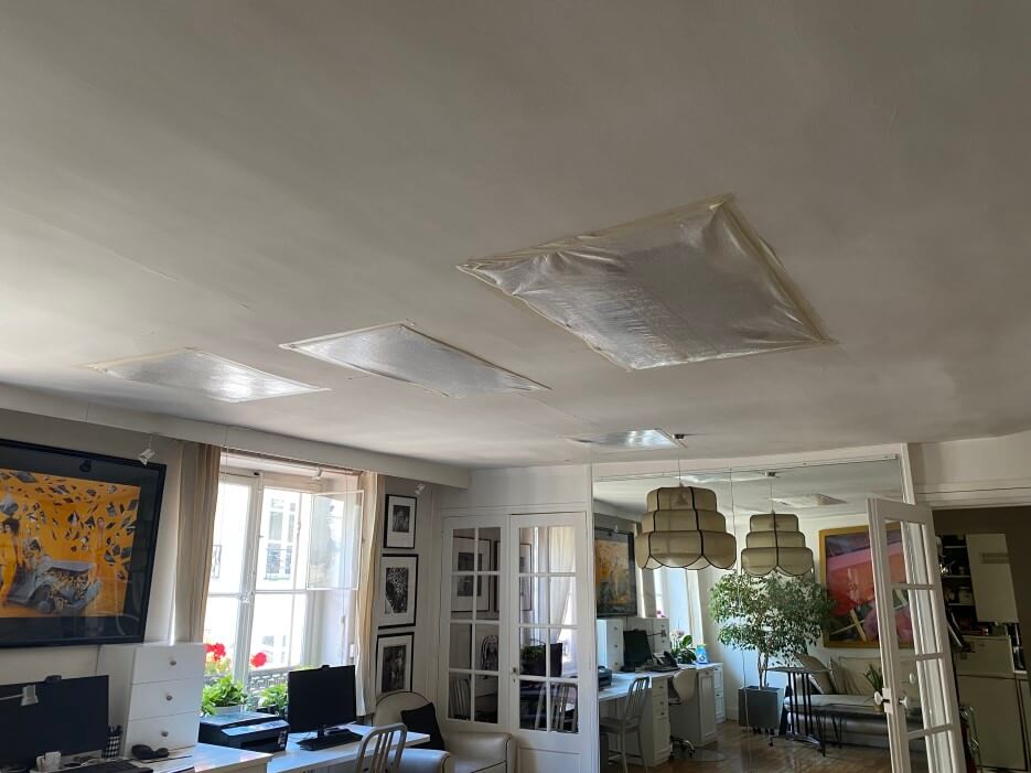 Photo of the covered over holes in the ceiling of Adrian Leeds' apartment in Paris France