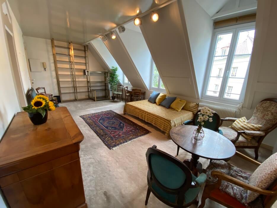 Interior view of the apartment for sale in Paris showing it's three large windows