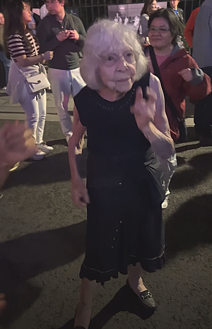 Elderly woman dancing at the bal des pompiers in Paris