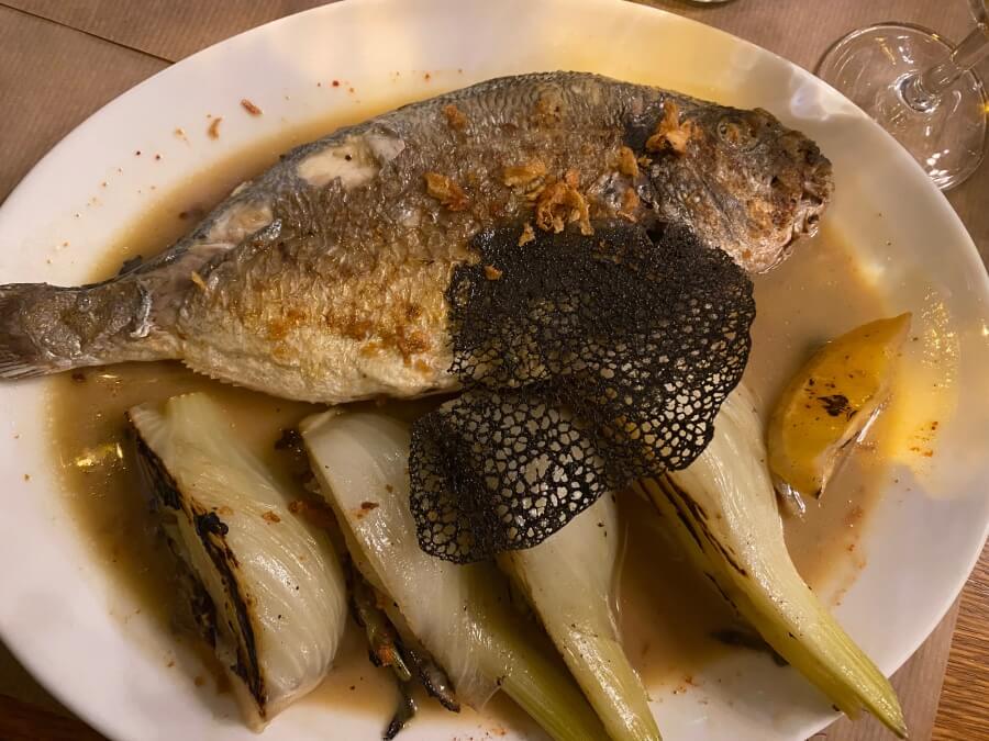 A plate of French food, fish and vegetables