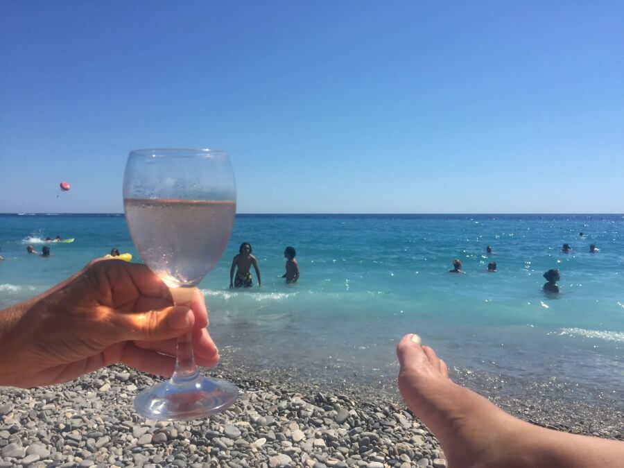 Sipping a glass of French rosé on the beach