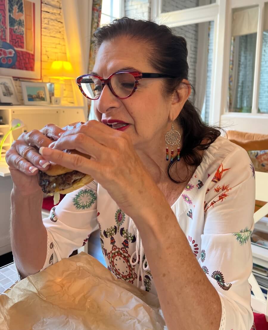 Adrian Leeds eating An "American" hamburger for All Star Burgers in Nice, France
