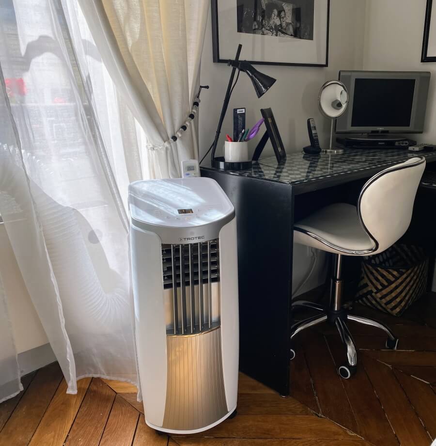 A portable AC unit piped out the window