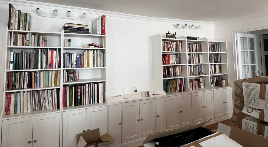 Organizing Adrian Leeds' books on the new book shelving in the renovated apartment in Paris